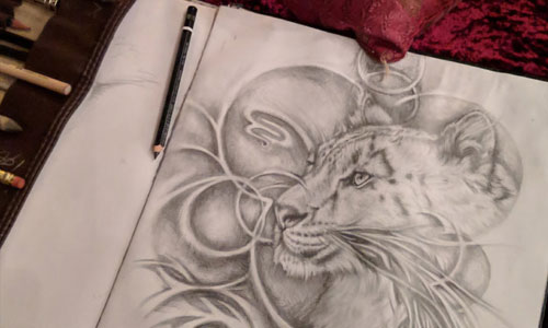 open sketchbook with a drawing of a wild cat